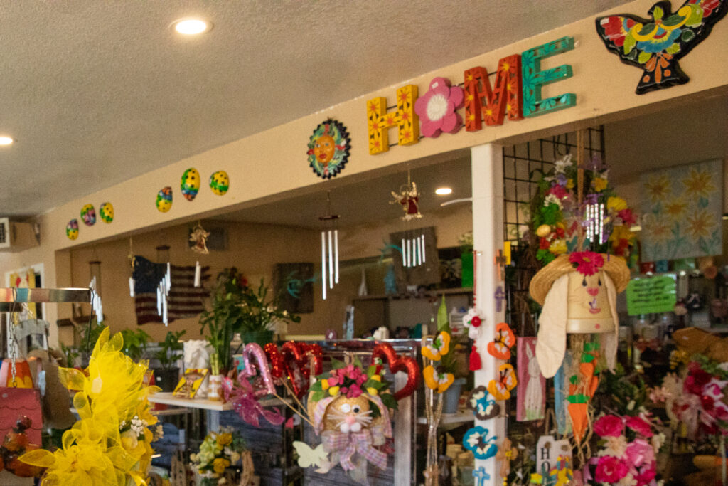 A photo of the inside of Arnie's Nursery and Gifts shows colorful arrangements and a sign reading "home."