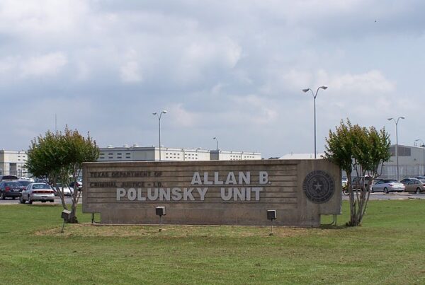 An outdoor stone sign reads "Texas Department of Criminal Justice / Allan B. Polunsky Unit"