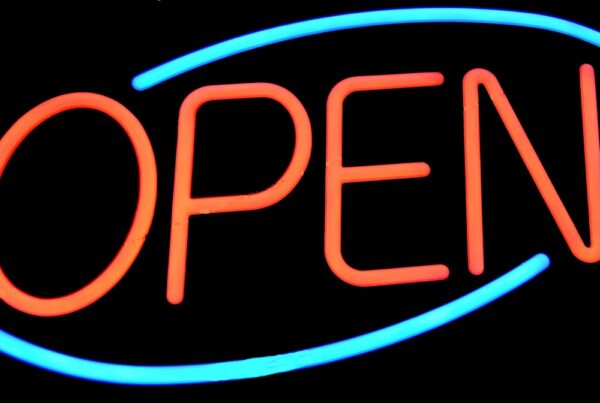 A neon sign says "OPEN" in red letters