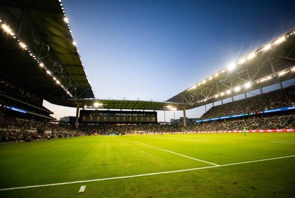 A shot of the field at a soccer stadium as the sun goes down