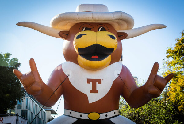 A large inflatable longhorn wearing a cowboy hat and with a "T" on its chest