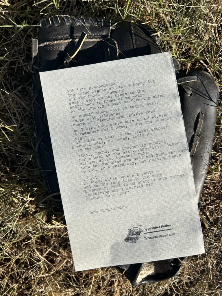 A photo of the typewritten poem on a sheet of light paper, placed on top of a baseball glove in the grass