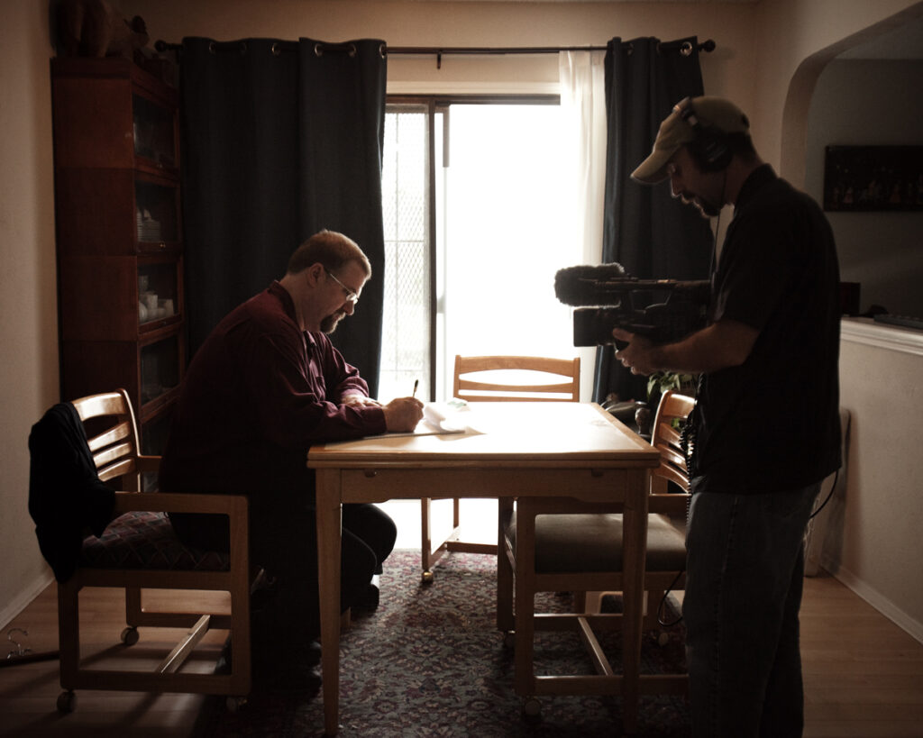 One man sits at a kitchen table